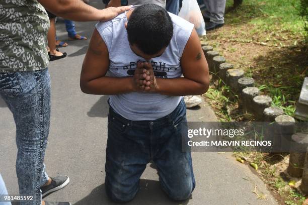 Man -who had been arrested in recent protests- prays after being released from jail in Managua, Nicaragua on June 22, 2018. - Ten people were helped...