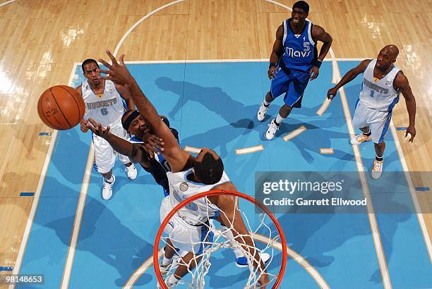 Jason Terry of the Dallas Mavericks lays up a shot against Malik Allen of the Denver Nuggets during the game on February 9, 2010 at the Pepsi Center...