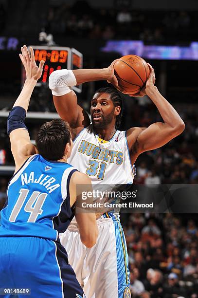 Nene of the Denver Nuggets looks to move the ball against Eduardo Najera of the Dallas Mavericks during the game on February 9, 2010 at the Pepsi...