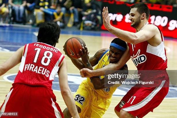 Daniel Ewing, #32 of Asseco Prokom competes with Linas Kleiza, #11 of Olympiacos Pireus in action during the Euroleague Basketball 2009-2010 Play Off...