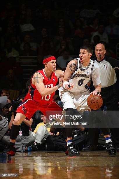 Mike Miller of the Washington Wizards posts up against Mike Bibby of the Atlanta Hawks during the game on March 11, 2010 at the Verizon Center in...