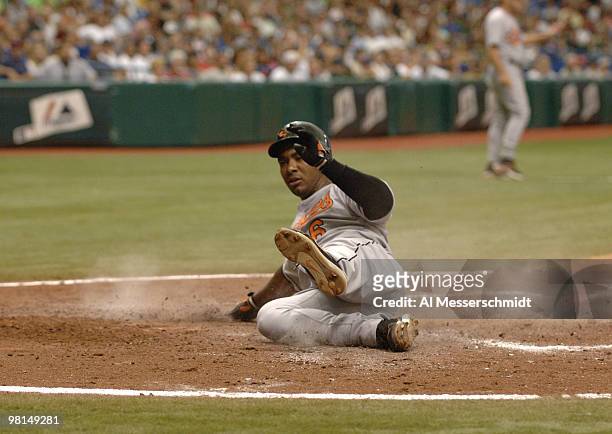 Baltimore Orioles Melvin Mora slides into home plate against the Tampa Bay Devil Rays July 23, 2006 in St. Petersburg. The Orioles defeated the Rays...