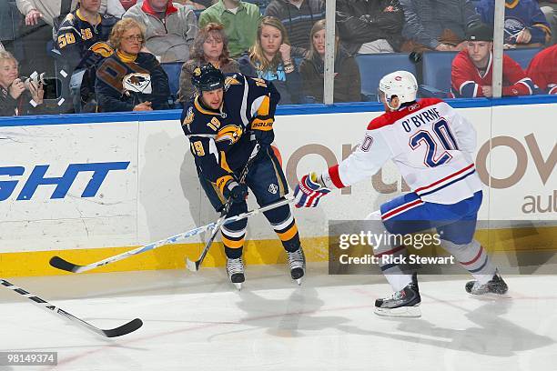 Tim Connolly of the Buffalo Sabres passes the puck against Ryan O'Byrne of the Montreal Canadiens at HSBC Arena on March 24, 2010 in Buffalo, New...