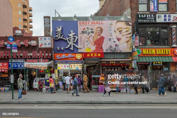 street life in main street in flushing - chinatown stock pictures, royalty-free photos & images