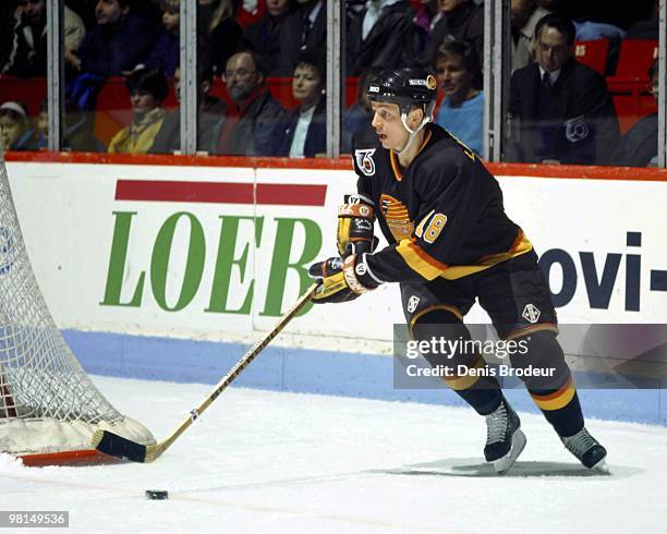 Igor Larionov of the Vancouver Canucks skates with the puck against the Montreal Canadiens in the early 1990's at the Montreal Forum in Montreal,...