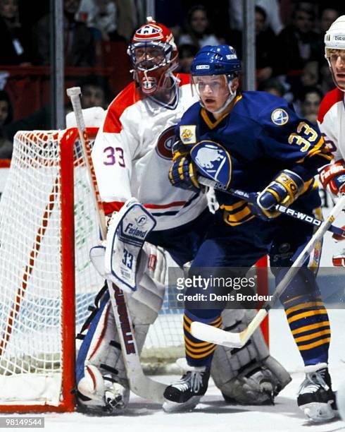 Benoit Hogue of the Buffalo Sabres positions himself in front of goaltender Patrick Roy of the Montreal Canadiens in the late 1980's at the Montreal...
