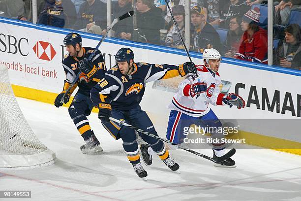 Paul Gaustad of the Buffalo Sabres pushes Tomas Plekanec of the Montreal Canadiens at HSBC Arena on March 24, 2010 in Buffalo, New York.