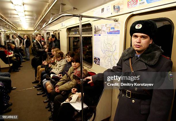 Russian military serviceman patroling a carriage of Moscow's metro train at the Lubyanka metro station in Moscow on March 30, 2010. Grieving Russians...