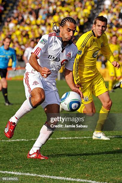 Forward Dwayne De Rosario of the Toronto FC controls the ball in front of defenseman Eric Brunner of the Columbus Crew on March 27, 2010 at Crew...