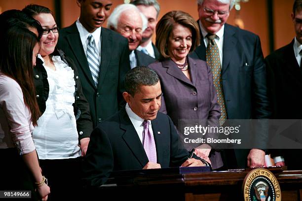 President Barack Obama signs the Health Care and Education Reconciliation Act of 2010 at Northern Virginia Community College with House Speaker Nancy...