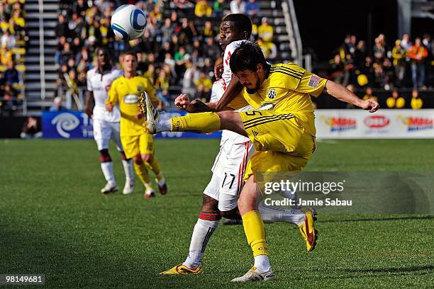 Midfielder Danny O'Rourke of the Columbus Crew kicks the ball away from forward O'Brian White of the Toronto FC on March 27, 2010 at Crew Stadium in...