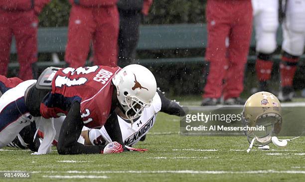Notre Dame wide receiver Rhema McKnight loses his helmet as Texas defensive back Aaron Ross defends for the South team at the 2007 Under Armour...