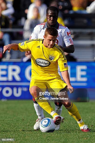Forward Robbie Rogers of the Columbus Crew controls the ball in front of defenseman Nana Attakora of the Toronto FC on March 27, 2010 at Crew Stadium...