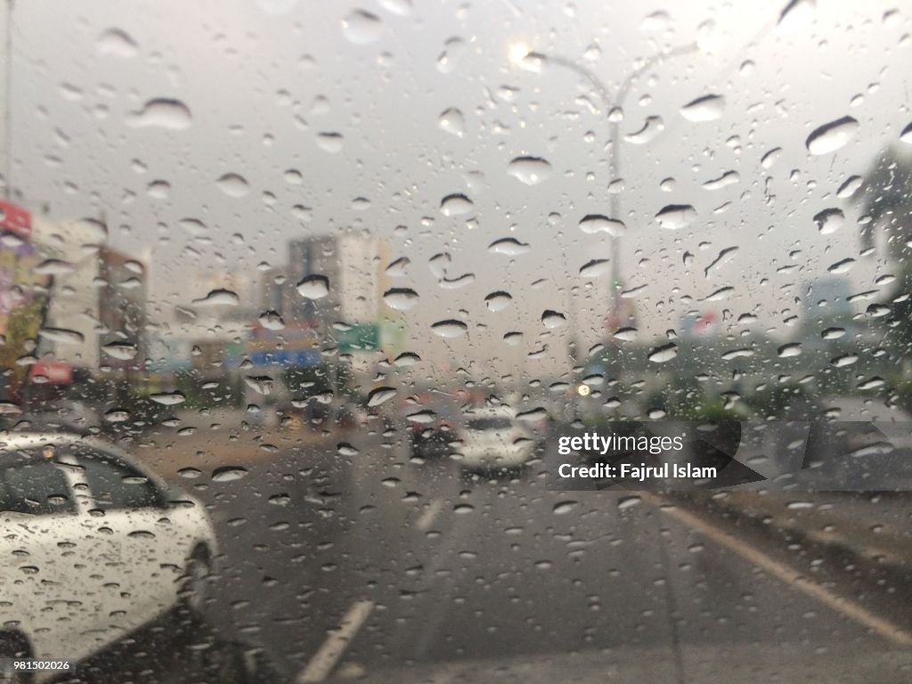 Raindrops at windshield in the city