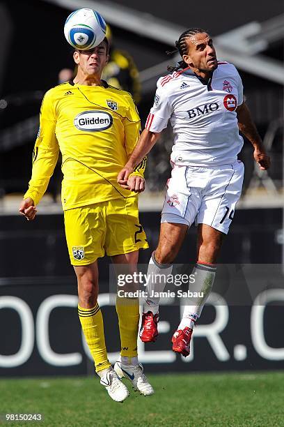 Defenseman Eric Brunner of the Columbus Crew heads the ball away from forward Dwayne De Rosario of the Toronto FC on March 27, 2010 at Crew Stadium...