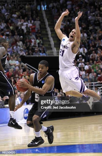 Ronald Nored of the Butler Bulldogs shoots against Denis Clemente of the Kansas State Wildcats during the west regional final of the 2010 NCAA men's...