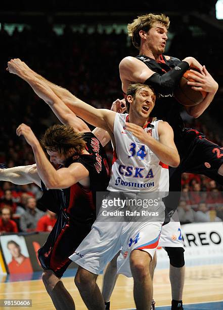 Tiago Splitter, #21 of Caja Laboral and Marcelinho Huertas, #9 of Caja Laboral compete with Zoran Planinic, #34 of CSKA Moscow during the Euroleague...