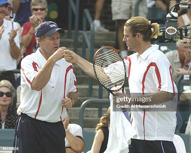 Captain Patrick McEnroe high fives Mardy Fish during the second match in the 2004 David Cup semifinal September 24, 2004 at Daniel Island, South...