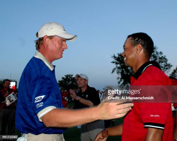 Ernie Els and Tiger Woods leave the 18th green after play in the 2005 Tavistock Cup at Isleworth Country Club March 29.