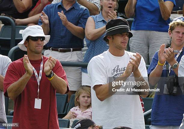 Coach Brad Gilbert and Andy Roddick applaud as Mardy Fish defeats Max Mirnyi at Family Circle Tennis Center during the second match in the 2004 David...