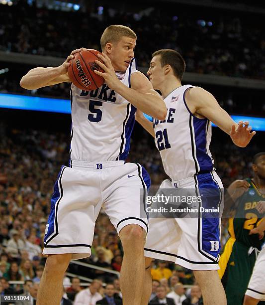 Mason Plumlee of the Duke Blue Devils grabs a rebound in front of teammate Miles Plumlee against the Baylor Bears during the south regional final of...