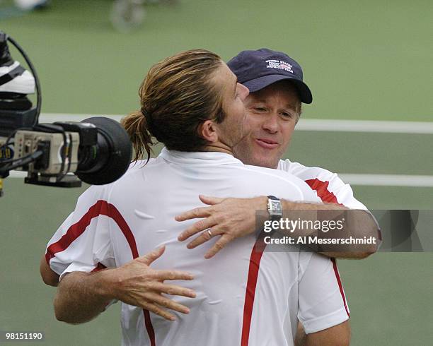 Mardy Fish hugs captain Patrick McEnroe after winning the second match in the 2004 David Cup semifinal September 24, 2004 at Daniel Island, South...