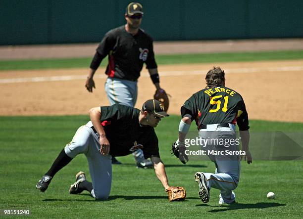 Shortstop Bobby Crosby and first baseman Steve Pearce of the Pittsburgh Pirates cannot get to in infield fly ball against the Minnesota Twins on...