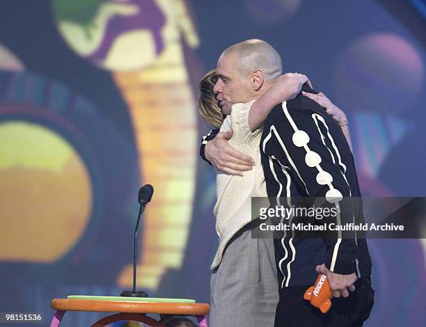Jim Carrey winner of the Favorite Male Movie Star Award receives a hug from presenter Kirsten Dunst