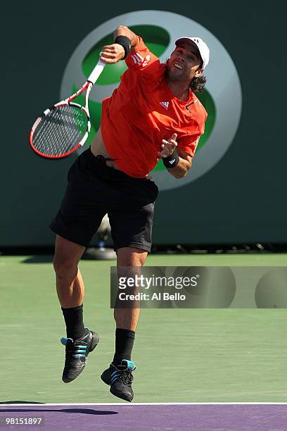 Fernando Gonzalez of Chile serves against Robin Soderling of Sweden during day eight of the 2010 Sony Ericsson Open at Crandon Park Tennis Center on...