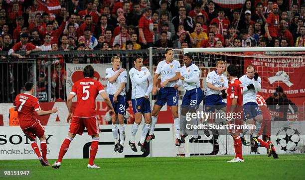 Franck Ribery of Bayern shoots the ball under a wall of players of Manchester to score the first goal during the UEFA Champions League quarter final,...