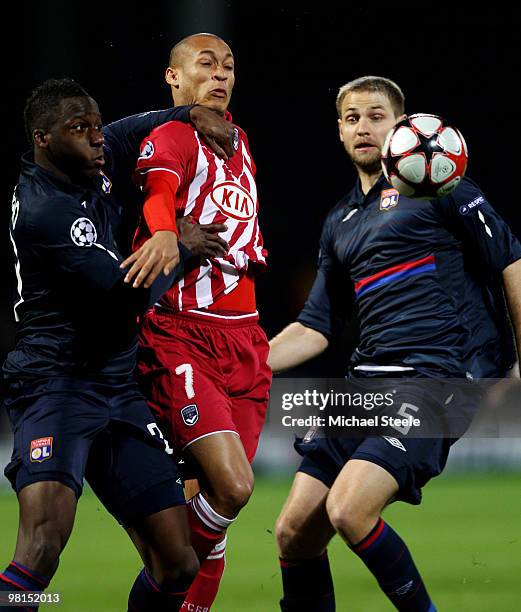 Yoan Gouffran of Bordeaux is sandwiched between Aly Cissokho and Mathieu Bodmer of Lyon during the Lyon v Bordeaux UEFA Champions League...