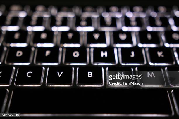 macbook pro led backlit keyboard - keyboard musical instrument stock pictures, royalty-free photos & images
