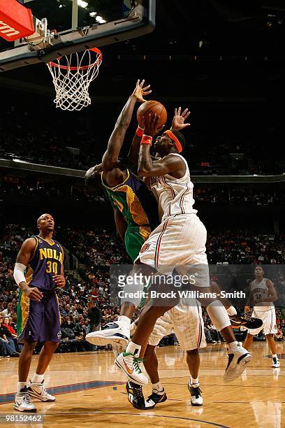 Stephen Jackson of the Charlotte Bobcats takes the ball to the basket against Emeka Okafor of the New Orleans Hornets during the game on February 6,...