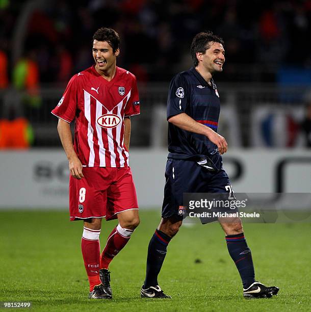 Yoann Gourcuff of Bordeaux jokes with Jeremy Toulalan of Lyon during the Lyon v Bordeaux UEFA Champions League quarter-final 1st leg match at the...