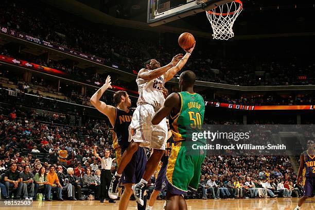 Stephen Graham of the Charlotte Bobcats lays up a shot against Darius Songaila and Emeka Okafor of the New Orleans Hornets during the game on...