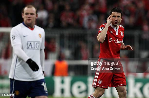 Mark van Bommel of Muenchen reacts as he walks past Wayne Rooney of Manchester during the UEFA Champions League quarter final first leg match between...