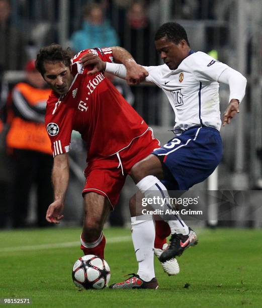 Hamit Altintop of Muenchen is challenged by Patrice Evra of Manchester during the UEFA Champions League quarter final first leg match between Bayern...