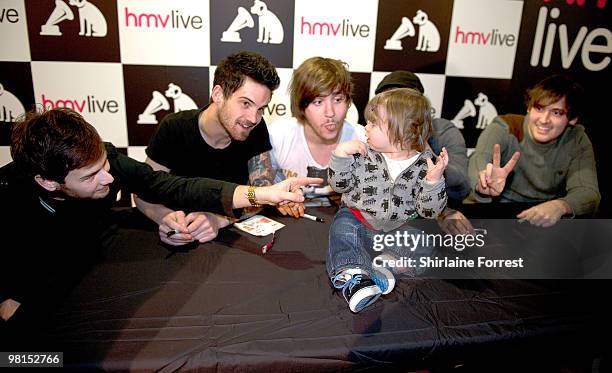 Joel Fisher, Andrew Shay, Aled Phillps, Iain Mahanty and Philip Jenkins of Kids in Glass Houses sign their new album 'Dirt' for young fan Paige after...