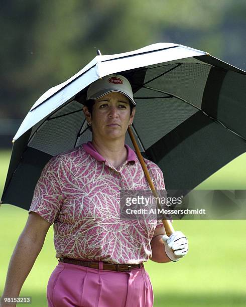 Danielle Ammaccapane grabs an umbrella as shelter from the heat on the 17th hole at the Jamie Farr Kroger Classic August 11, 2003 in Sylvania, Ohio.