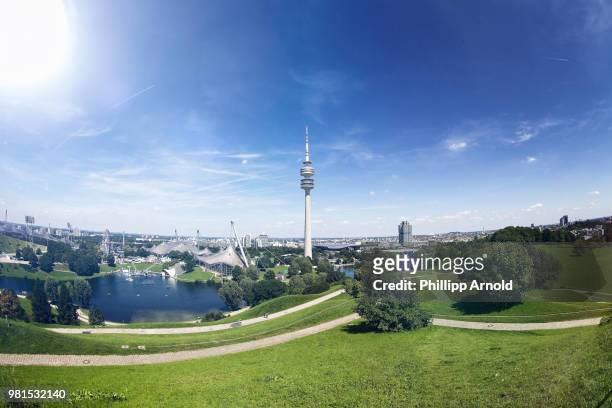 olympic tower in park under blue sky, munich, germany - munich stock pictures, royalty-free photos & images