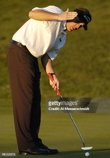 Phil Mickelson lines up a putt on the 18th green in the setting sun during first round competition January 29, 2004 at the 2004 FBR Open at the...