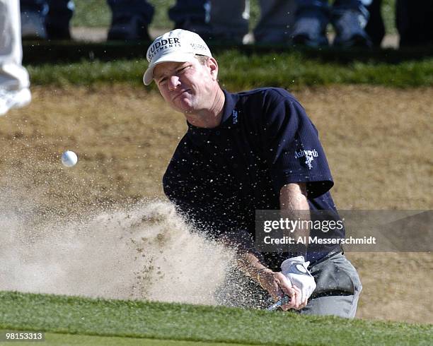 Scott Verplank blasts from the sand into the 18th green during first round competition January 29, 2004 at the 2004 FBR Open at the Tournament...
