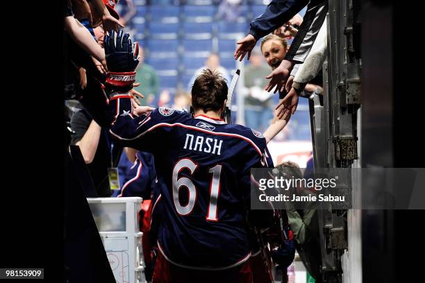Rick Nash of the Columbus Blue Jackets high fives fans on his way out to the ice for the warm-up prior to the start of the game against the the Tampa...