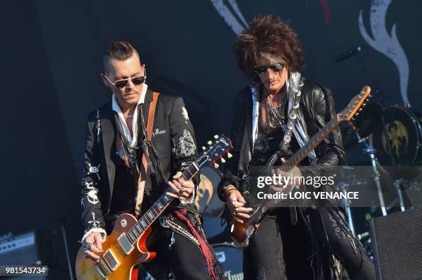 Actor Johnny Depp is flanked by US guitar player Joe Perry as they perform with The Hollywood Vampires band as part of the Hellfest metal music...