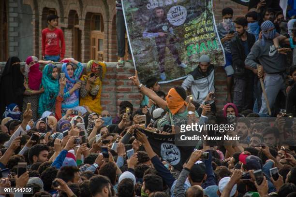 Masked Kashmri man shout anti Indian slogans as he attends the funeral of Dawood Salafi, a rebel commander killed in a gun battle with Indian...