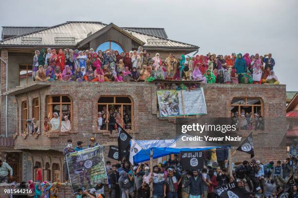 Kashmir Muslim women on a rooftop look towards the body being carried of Dawood Salafi, a rebel commander killed in a gun battle with Indian...