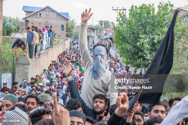 Masked Kashmri man shout anti Indian slogans as he attends the funeral of Dawood Salafi, a rebel commander killed in a gun battle with Indian...