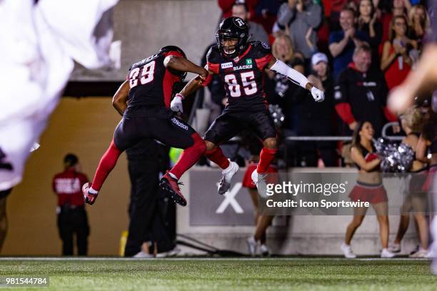 Ottawa RedBlacks wide receiver Diontae Spencer celebrates a touchdown with Ottawa RedBlacks running back William Powell during Canadian Football...