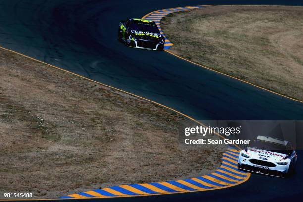 Brad Keselowski, driver of the Discount Tire Ford, leads Jimmie Johnson, driver of the Lowe's for Pros Chevrolet, practice for the Monster Energy...