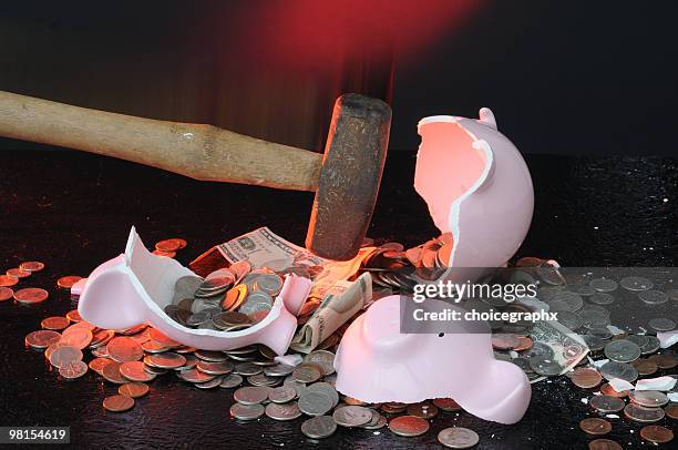 pink piggy bank being broken by a hammer with coins - smashed piggy bank stock pictures, royalty-free photos & images